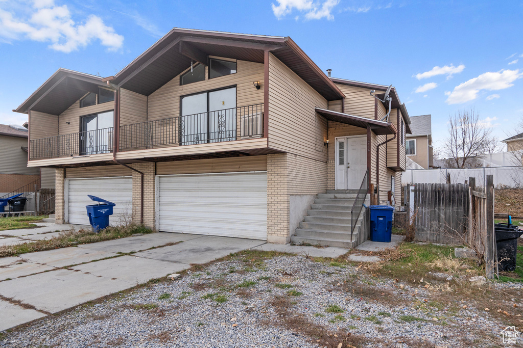 View of front of house with a balcony and a garage