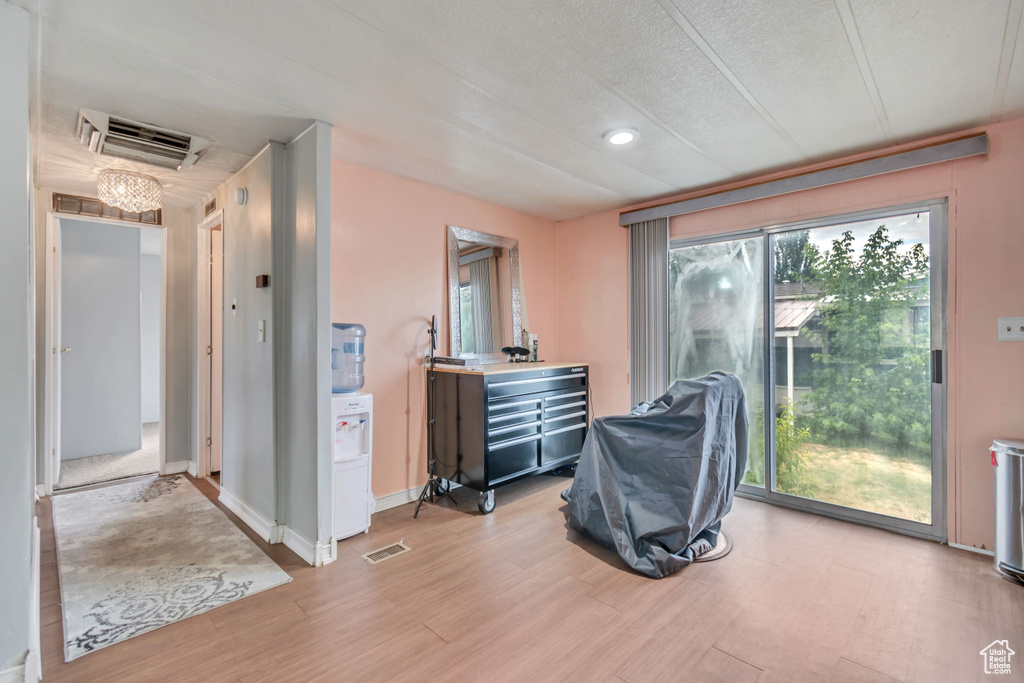 Interior space featuring light hardwood / wood-style floors, a textured ceiling, and plenty of natural light