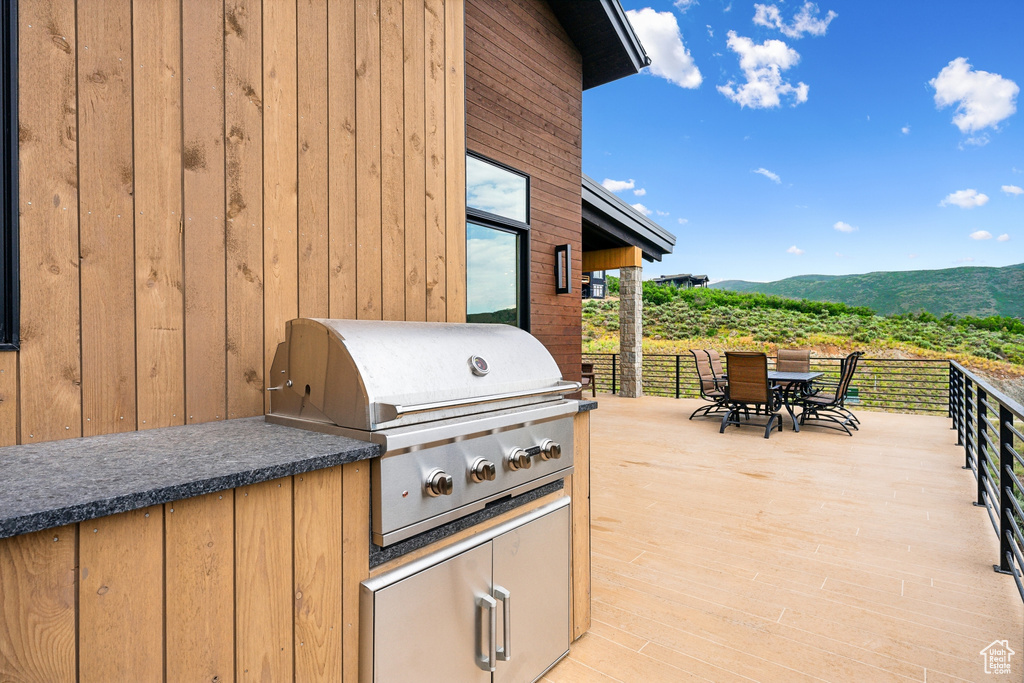 View of patio / terrace with area for grilling and a mountain view