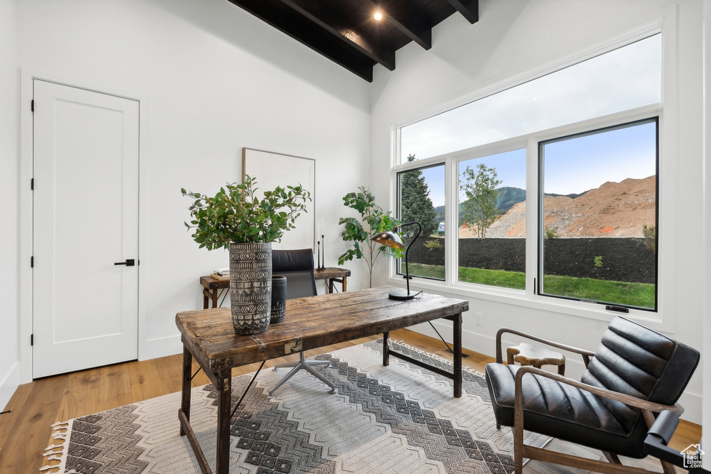 Office featuring high vaulted ceiling, hardwood / wood-style floors, and beam ceiling