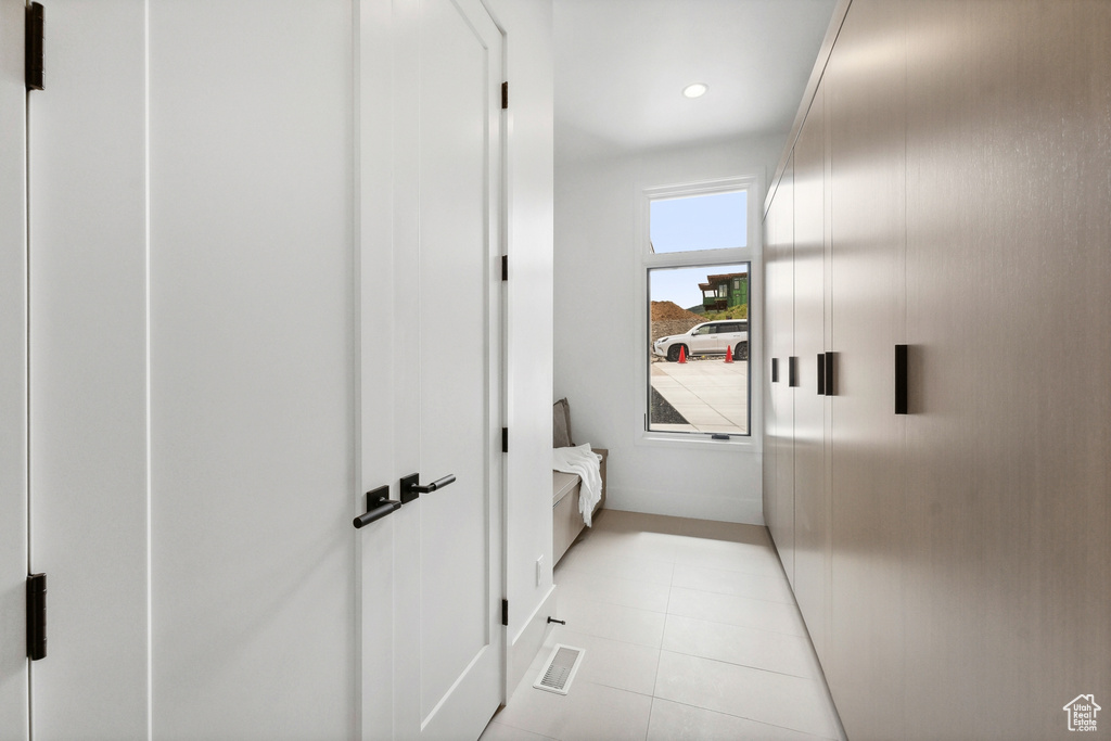 Corridor featuring light tile patterned floors