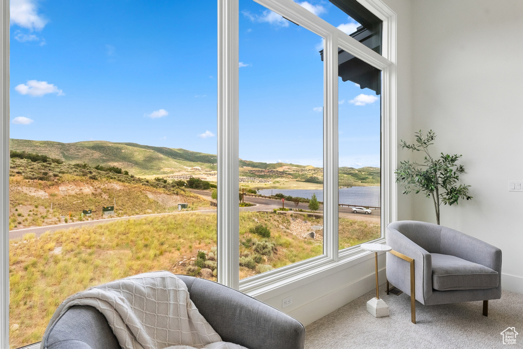 Sunroom / solarium featuring a water view