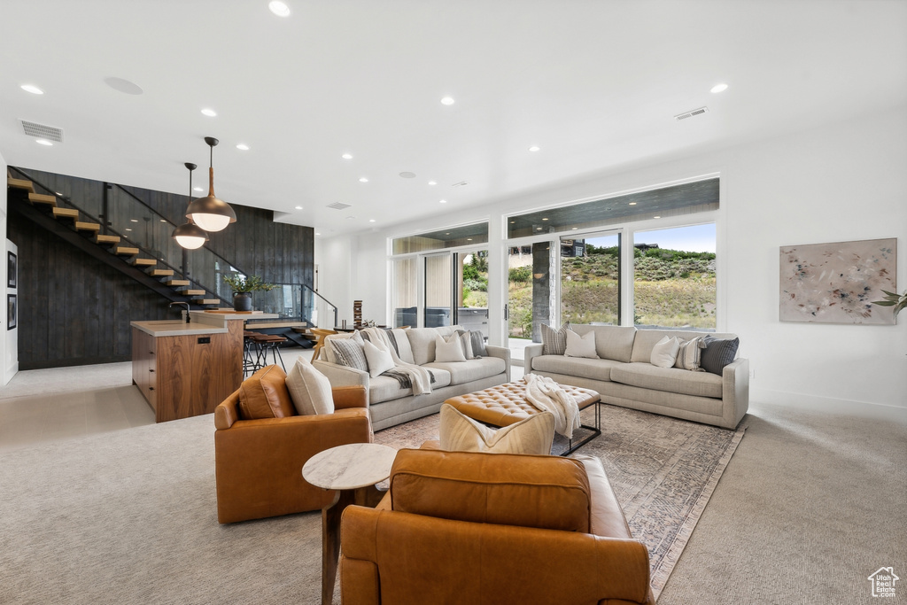 Carpeted living room featuring sink