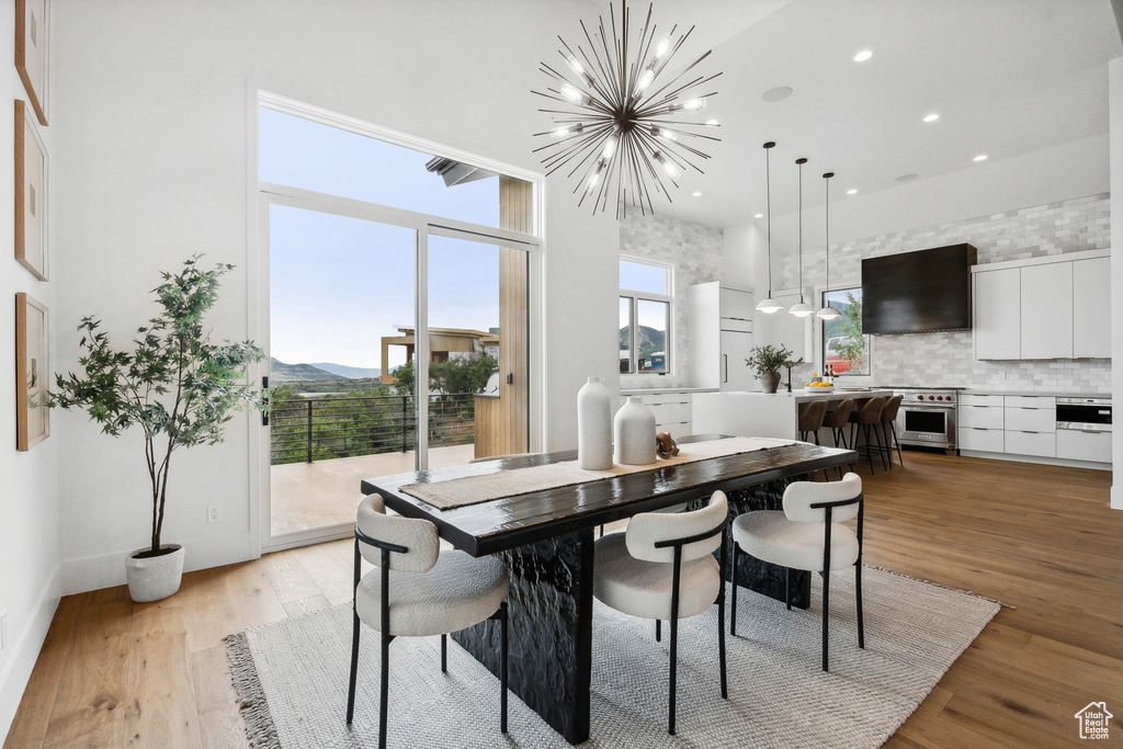 Dining space with a chandelier and light hardwood / wood-style floors