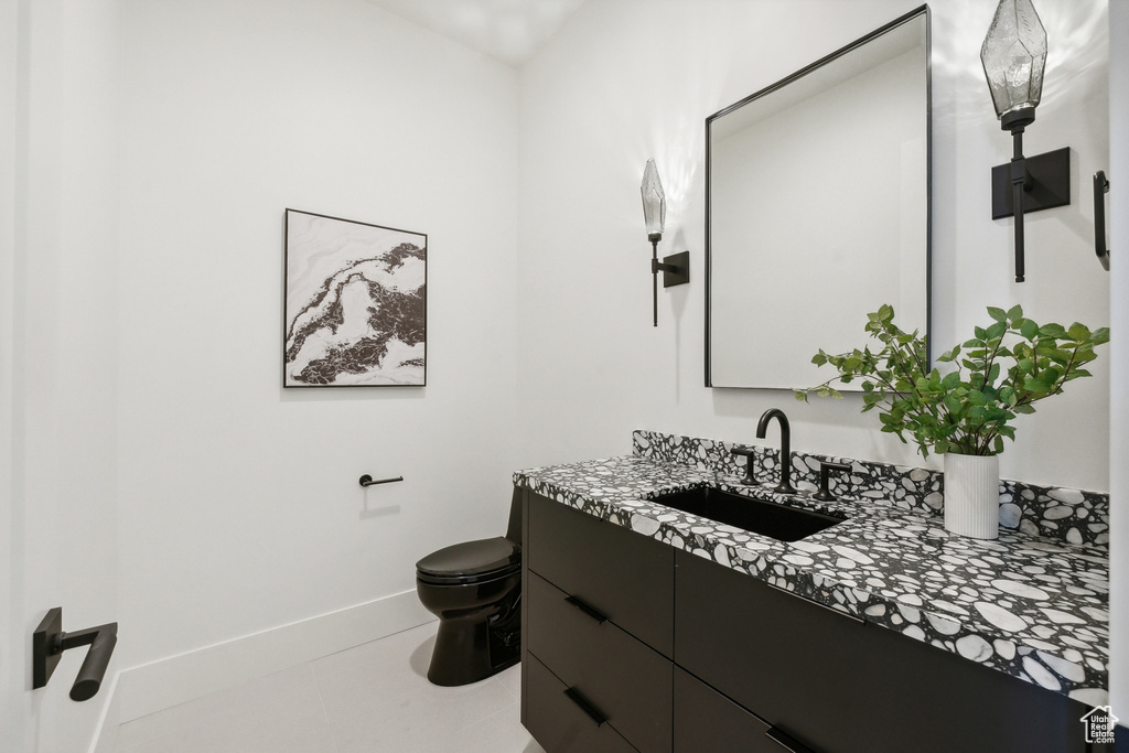 Bathroom with tile patterned flooring, toilet, and vanity