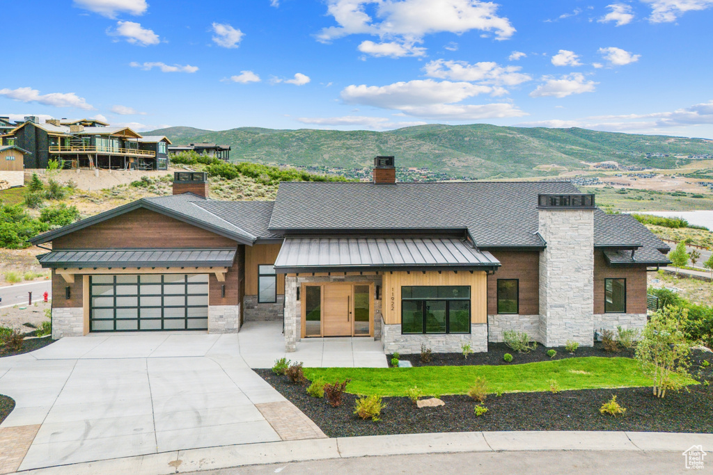 View of front of home featuring a mountain view and a garage