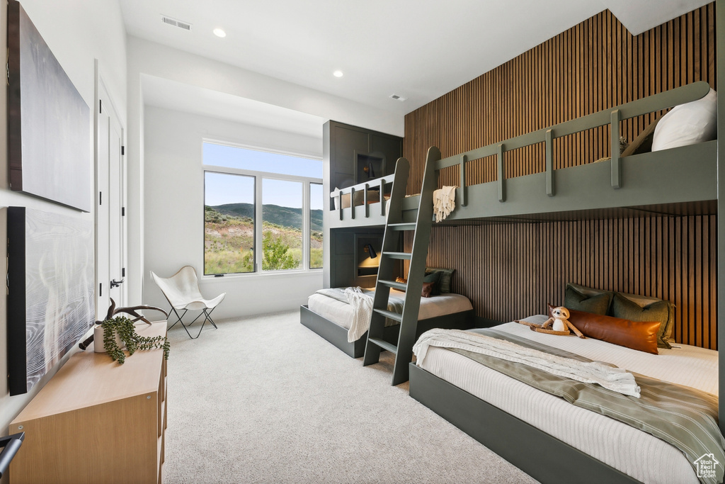 Carpeted bedroom featuring a fireplace