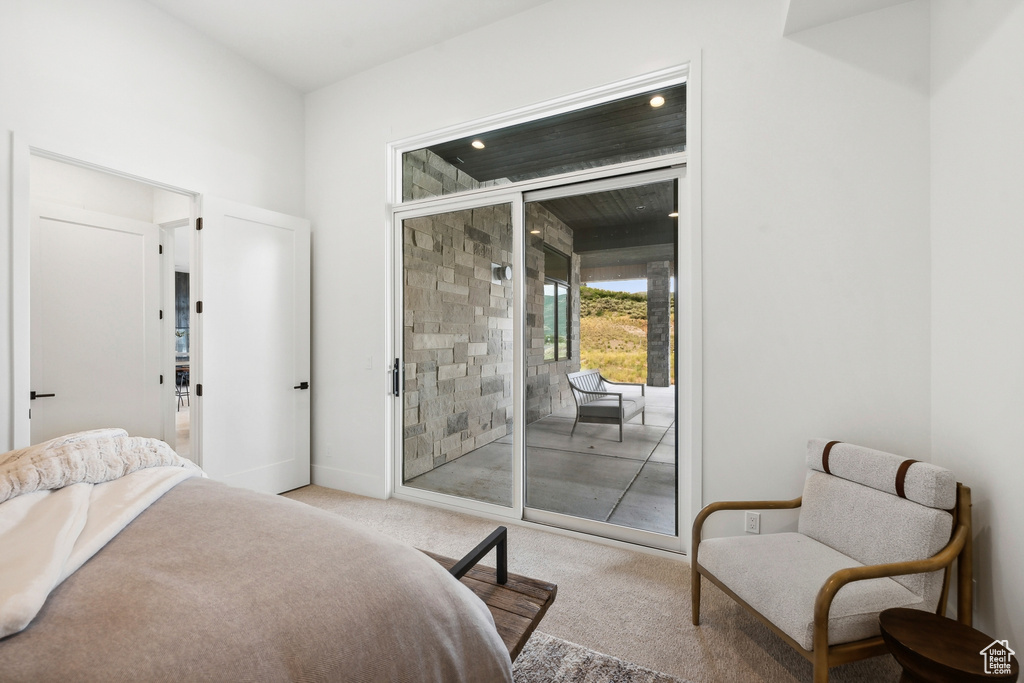 Carpeted bedroom featuring access to outside