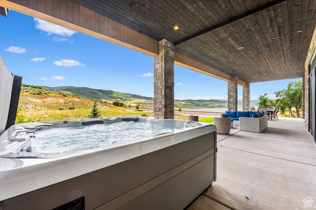 View of patio / terrace featuring a hot tub and an outdoor hangout area