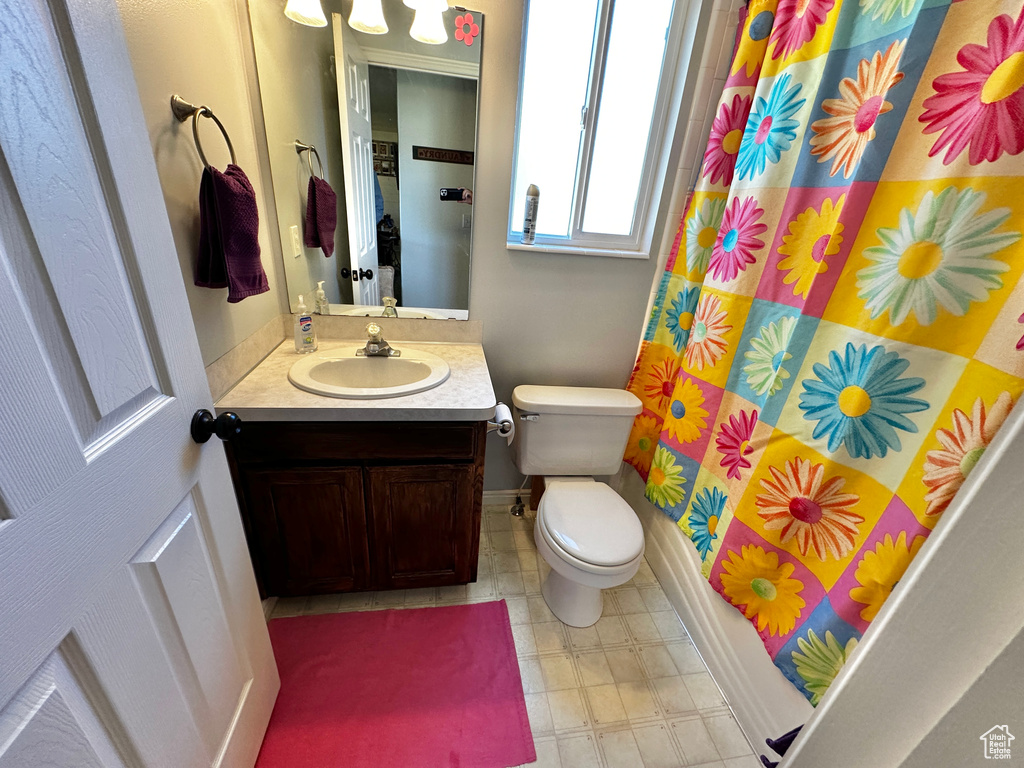 Bathroom with tile patterned floors, toilet, and vanity