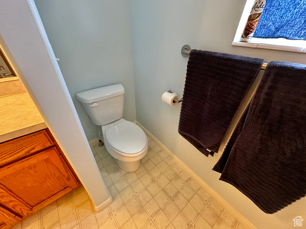 Bathroom with vanity, tile patterned flooring, and toilet