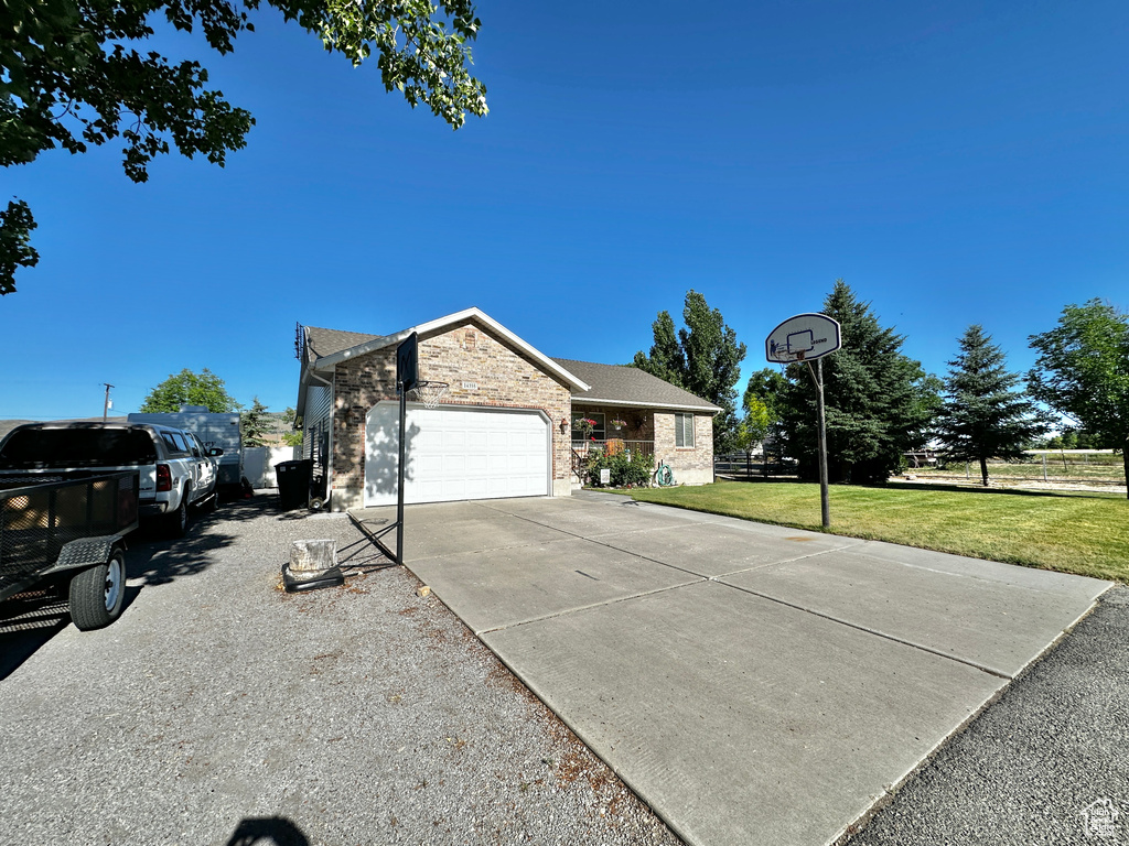 View of front of house with a garage and a front yard