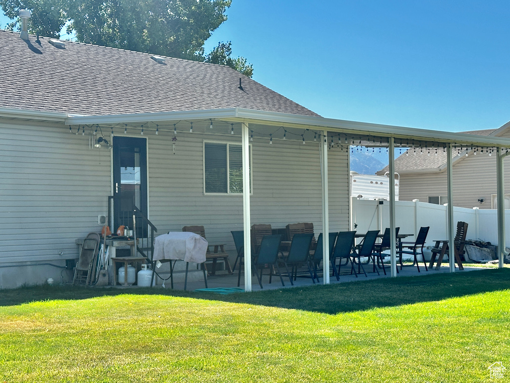 Rear view of house featuring a yard and a patio