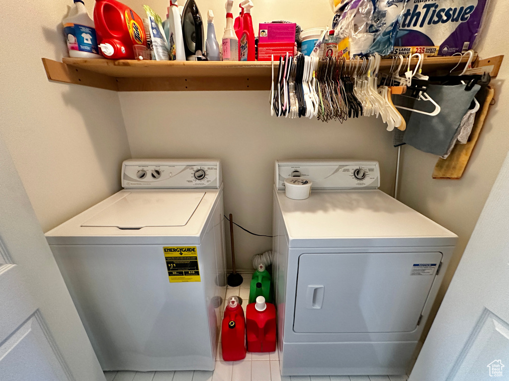 Washroom with tile patterned flooring and separate washer and dryer