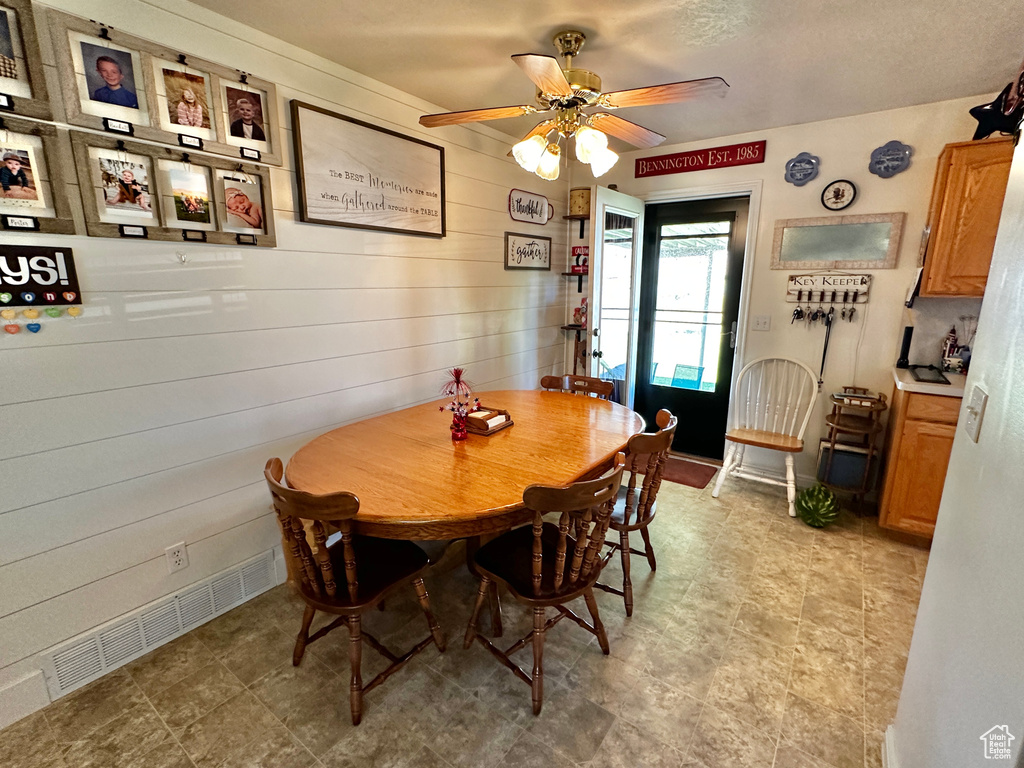 Dining room featuring tile patterned floors and ceiling fan