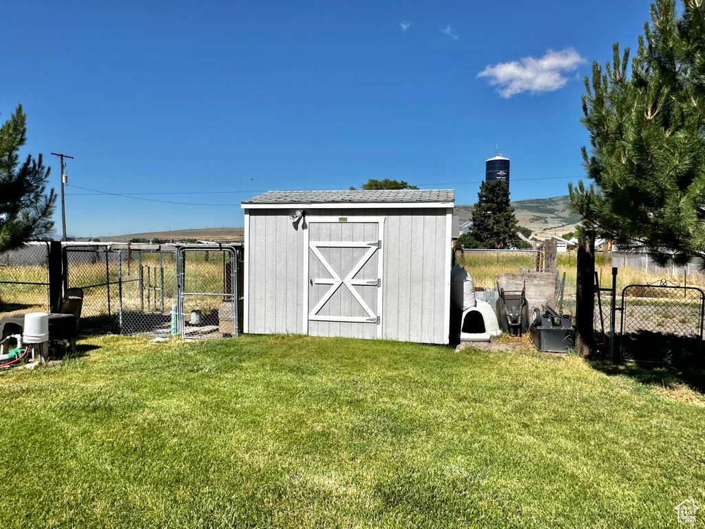 View of outdoor structure with a lawn