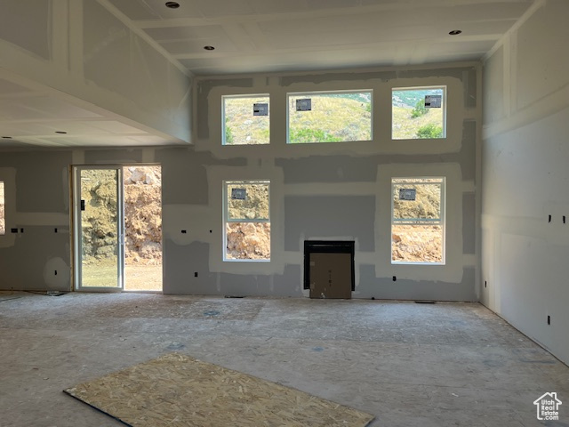 Unfurnished living room with a high ceiling