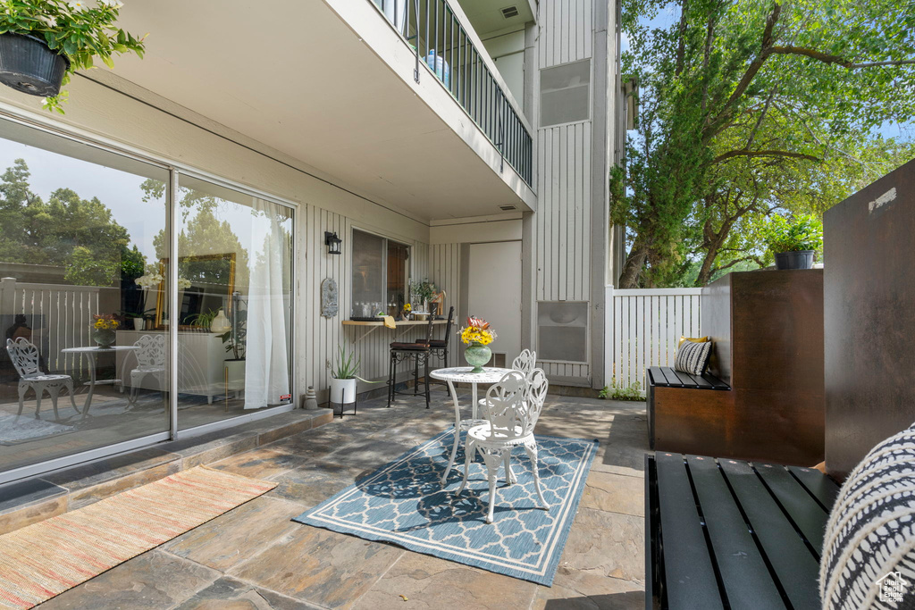 View of patio with a balcony