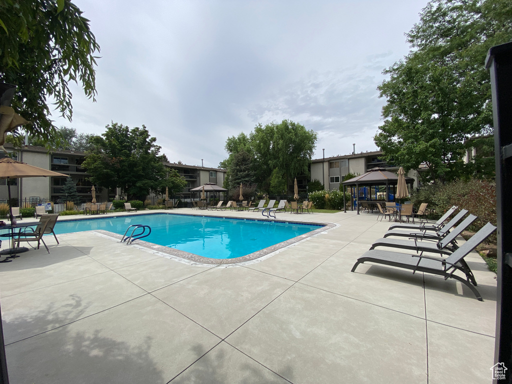 View of pool with a patio and a gazebo