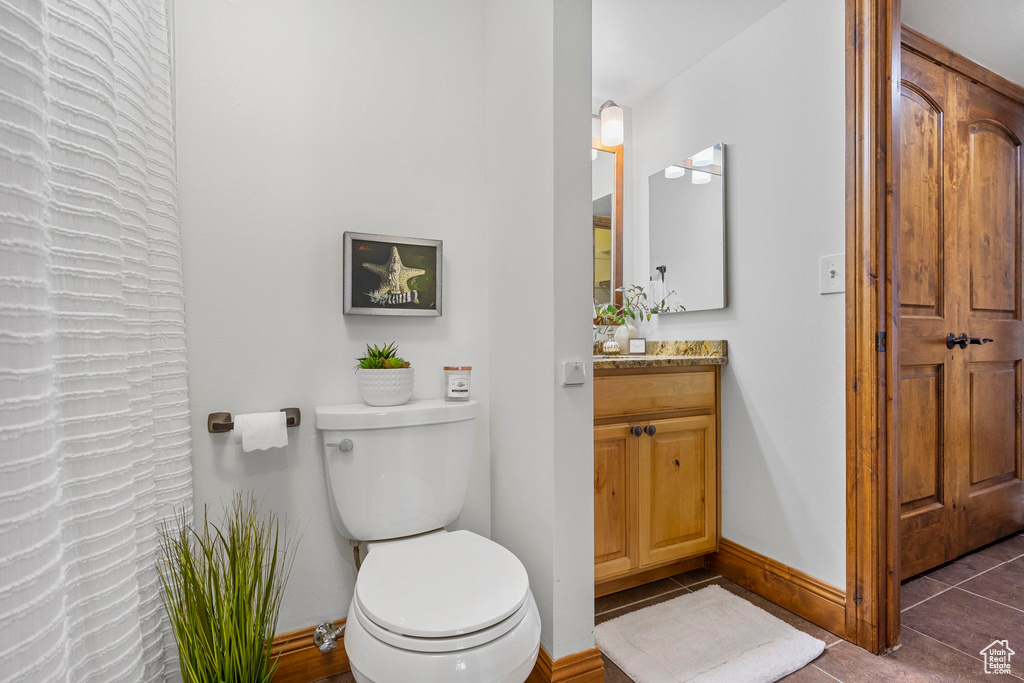 Bathroom with tile patterned floors, vanity, and toilet