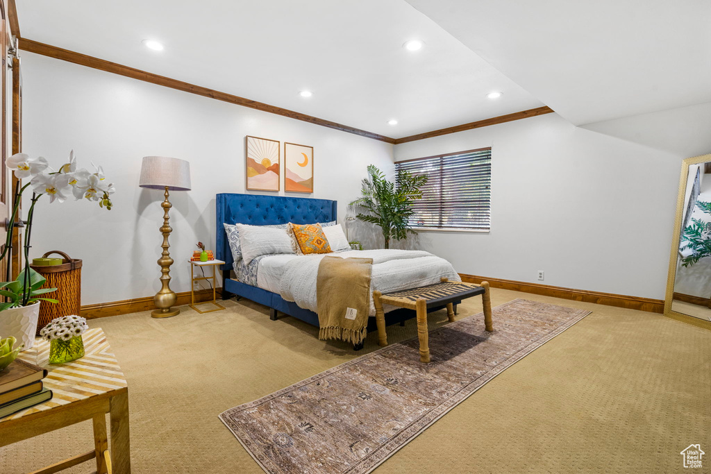 Carpeted bedroom featuring ornamental molding