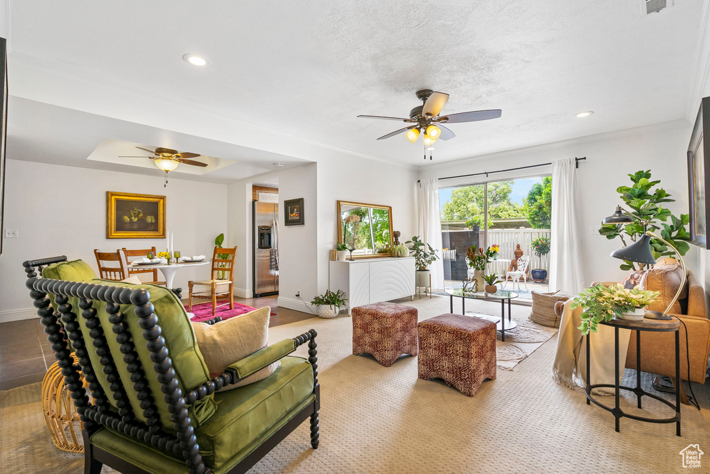 Living room with ceiling fan and ornamental molding