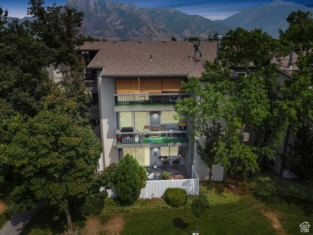 Back of property with a balcony and a mountain view