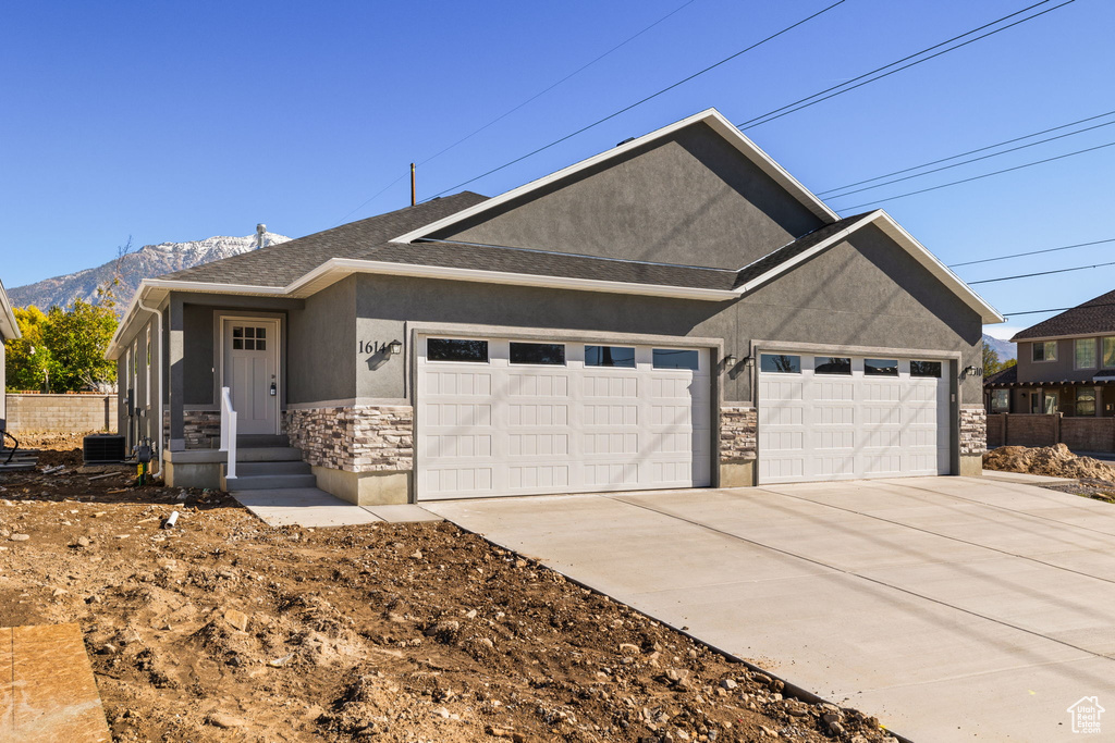 View of front of property featuring a mountain view and a garage