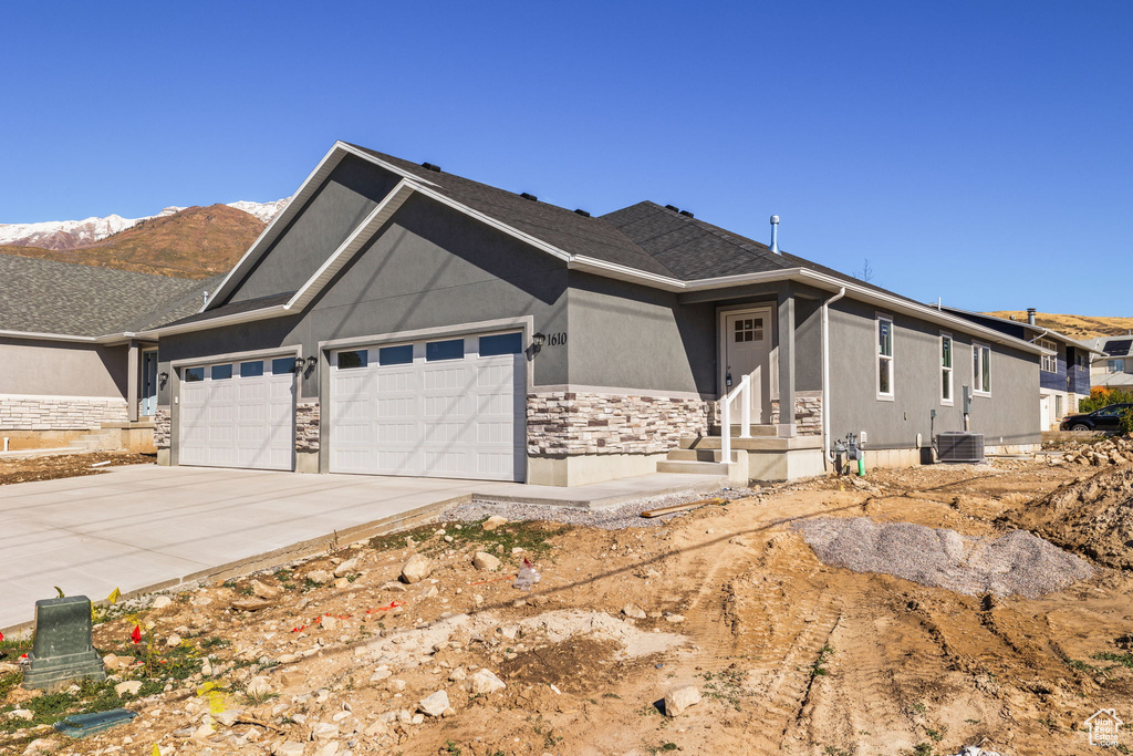 View of front of house featuring a mountain view and a garage