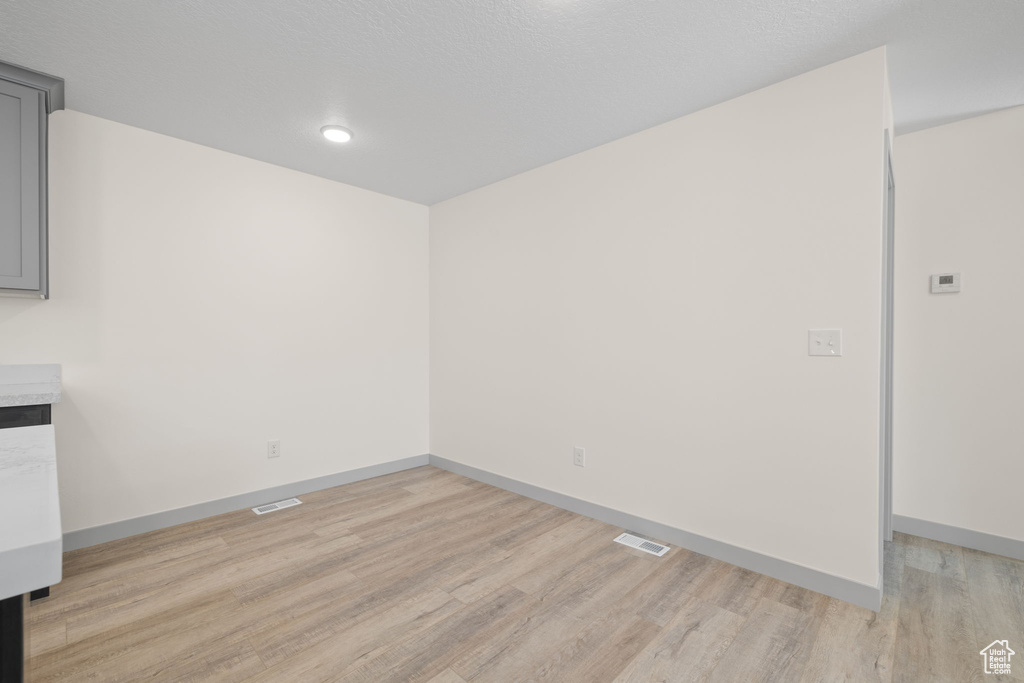 Unfurnished room featuring light wood-type flooring