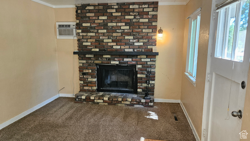 Unfurnished living room with brick wall, ornamental molding, carpet, and a fireplace