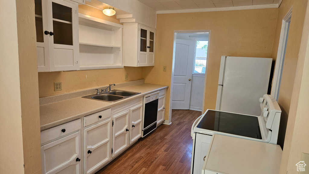 Kitchen with white appliances, sink, crown molding, dark hardwood / wood-style floors, and white cabinetry