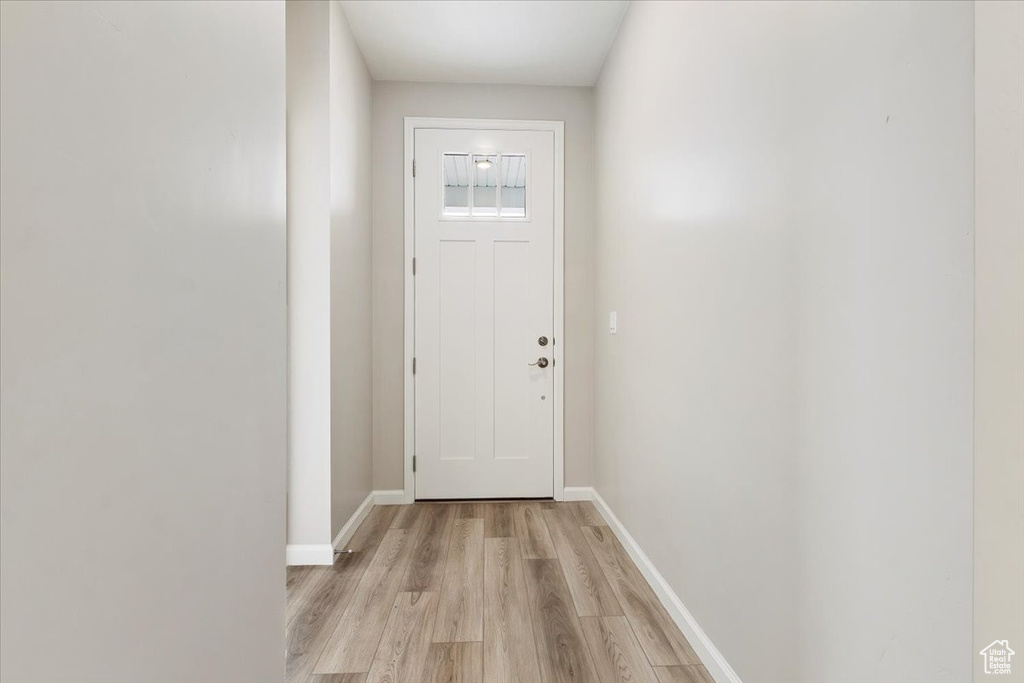 Doorway with light wood-type flooring