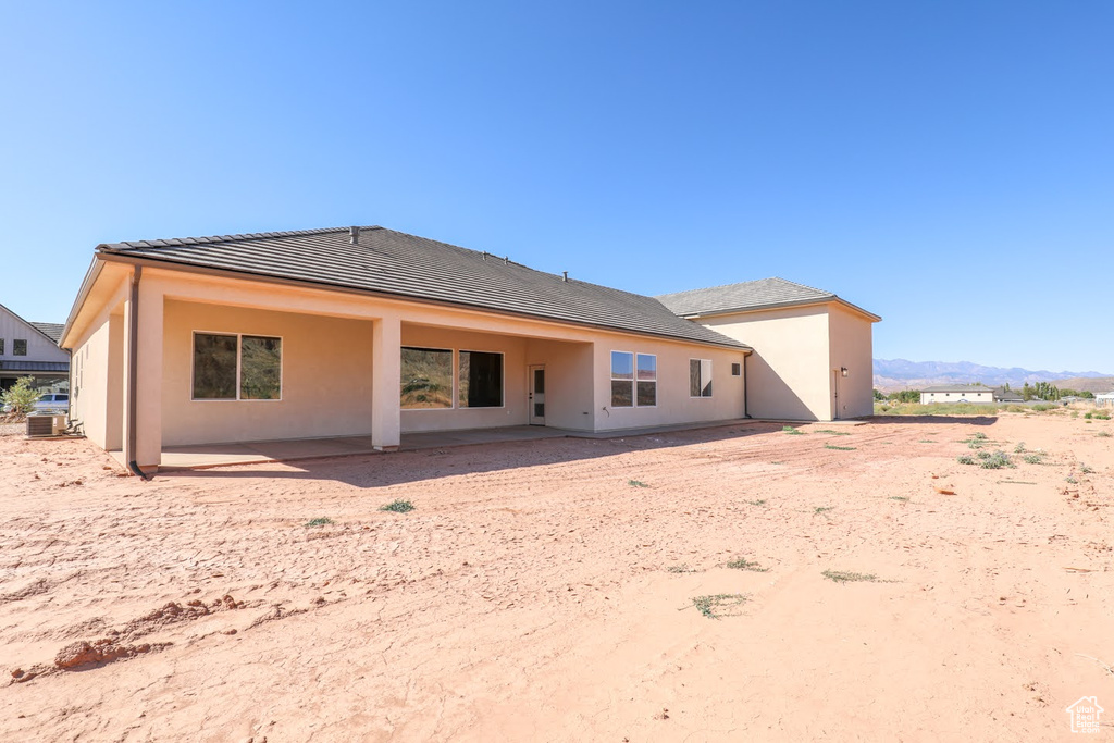 Back of house featuring a patio, a mountain view, and cooling unit