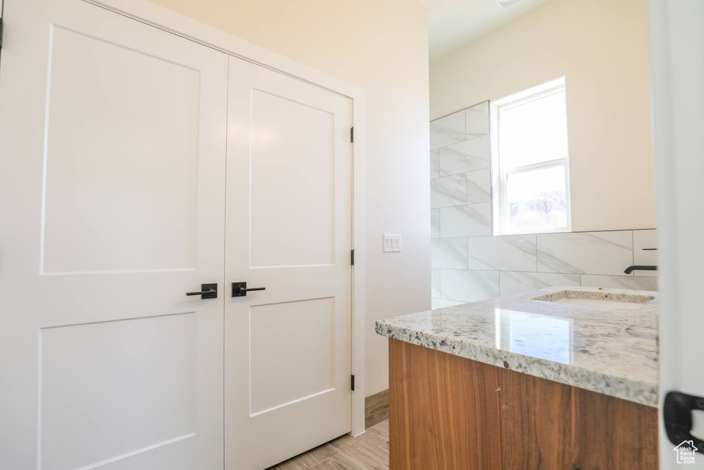 Bathroom with hardwood / wood-style flooring and vanity