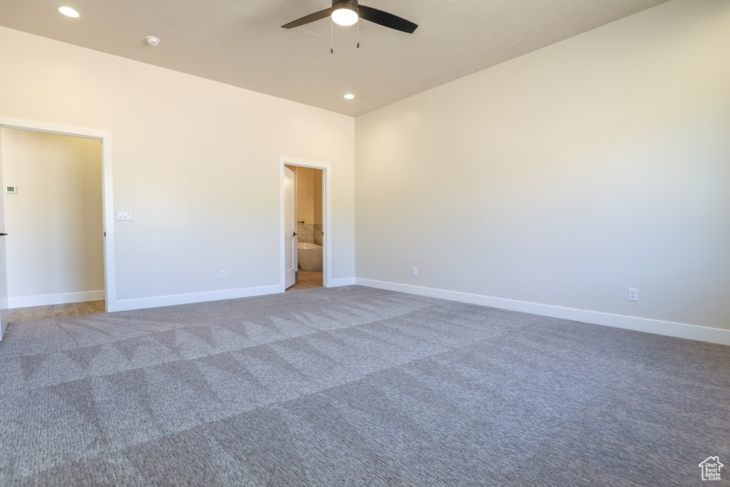 Empty room with ceiling fan and carpet floors