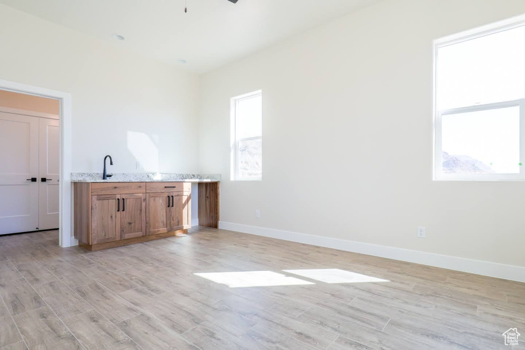 Empty room featuring ceiling fan and light hardwood / wood-style flooring