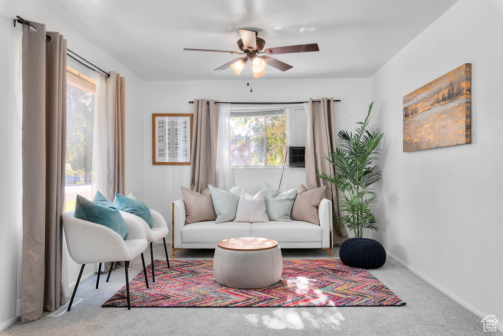 Sitting room featuring carpet and ceiling fan