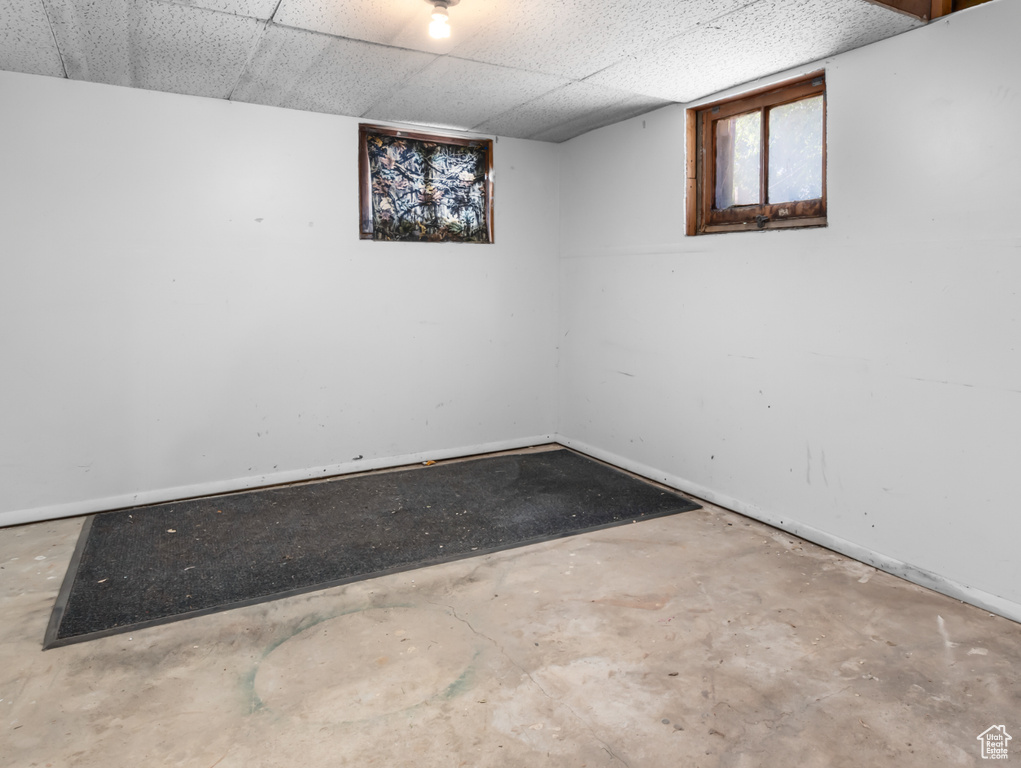 Spare room with concrete floors and a drop ceiling