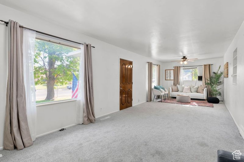 Interior space featuring ceiling fan and carpet flooring