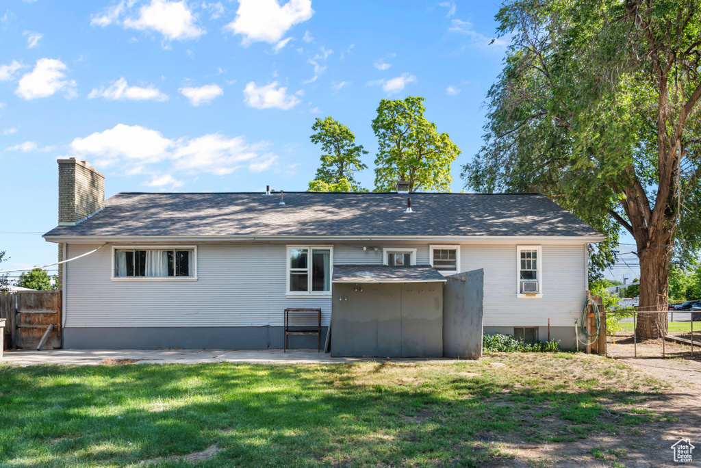 Rear view of house featuring a patio area and a lawn