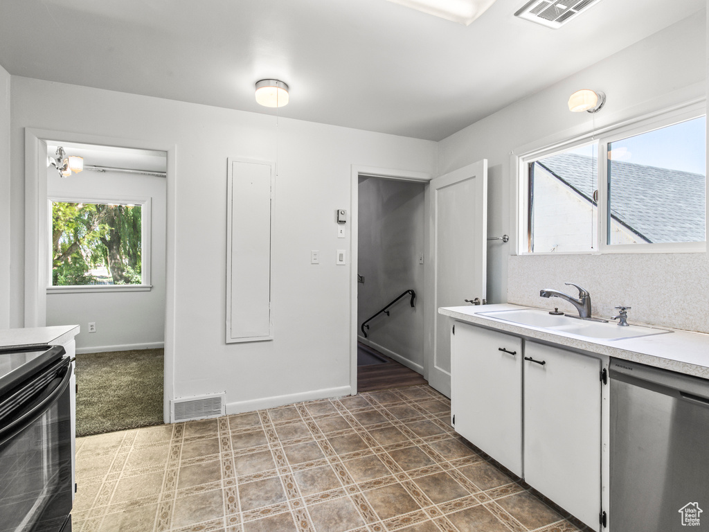 Bathroom with tile patterned floors and double sink vanity