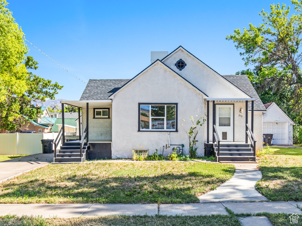 Bungalow with a garage and a front yard