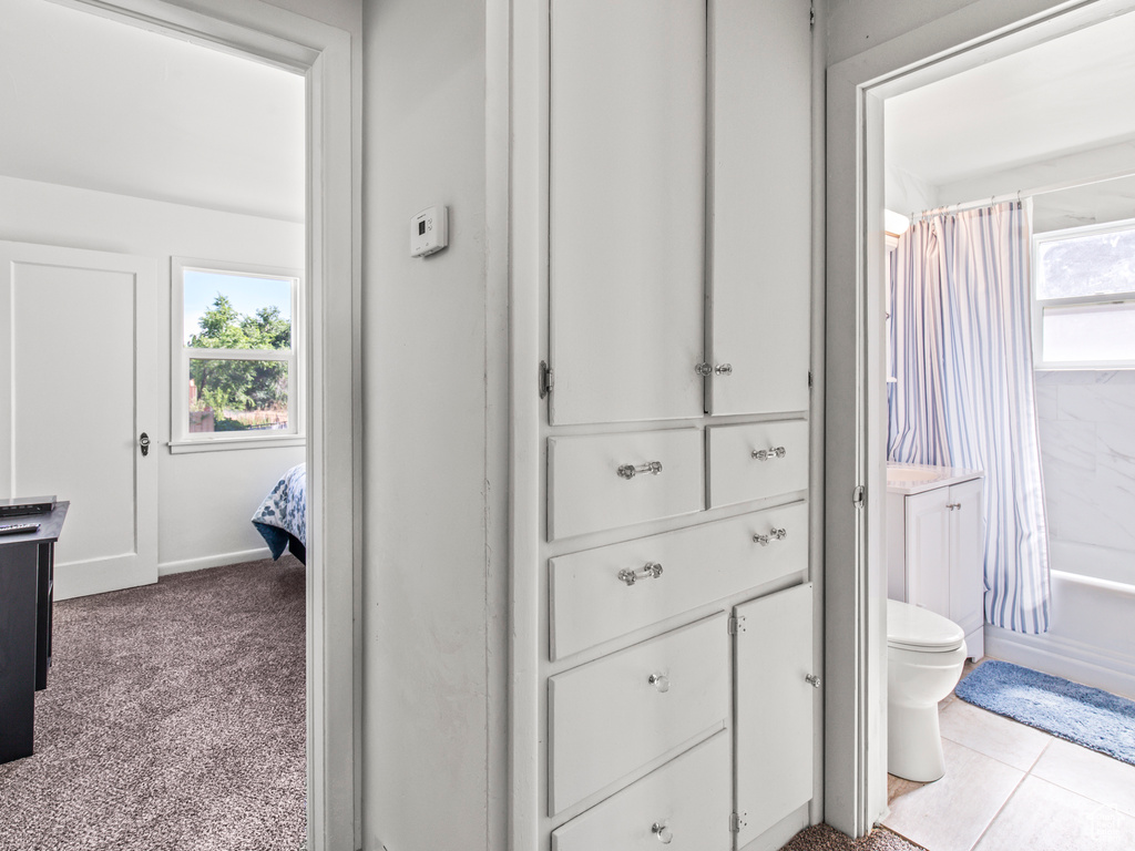 Full bathroom with tile patterned flooring, shower / bath combo, toilet, and vanity