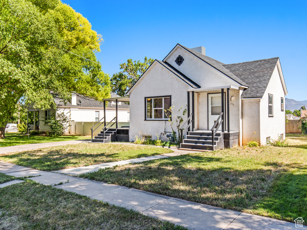 Bungalow-style home with a front yard