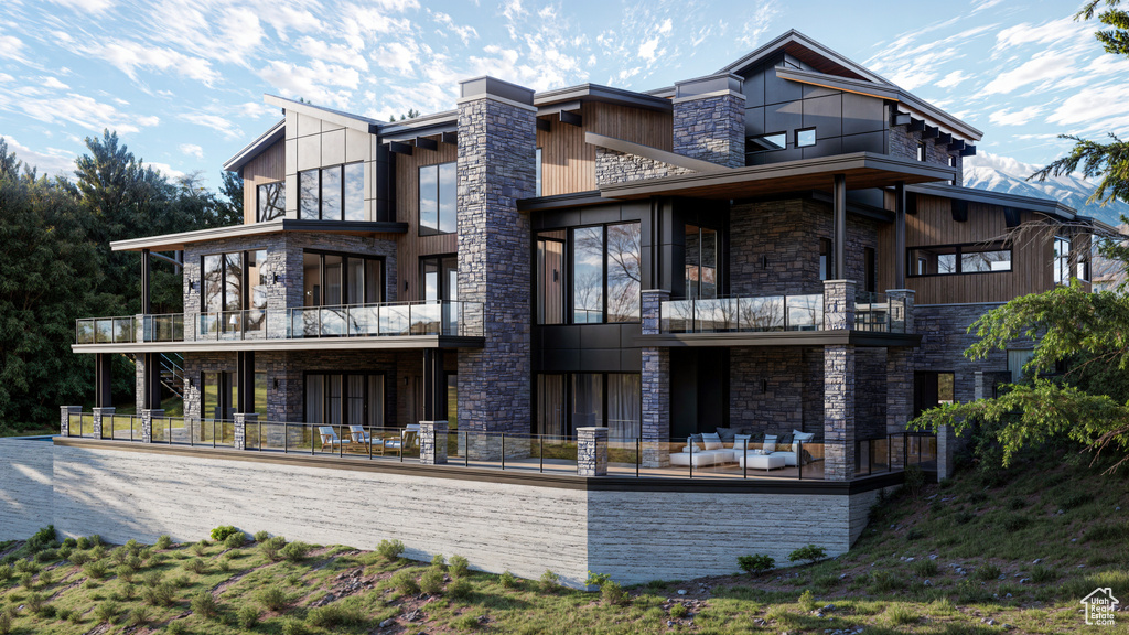 Rear view of property featuring an outdoor hangout area and a balcony