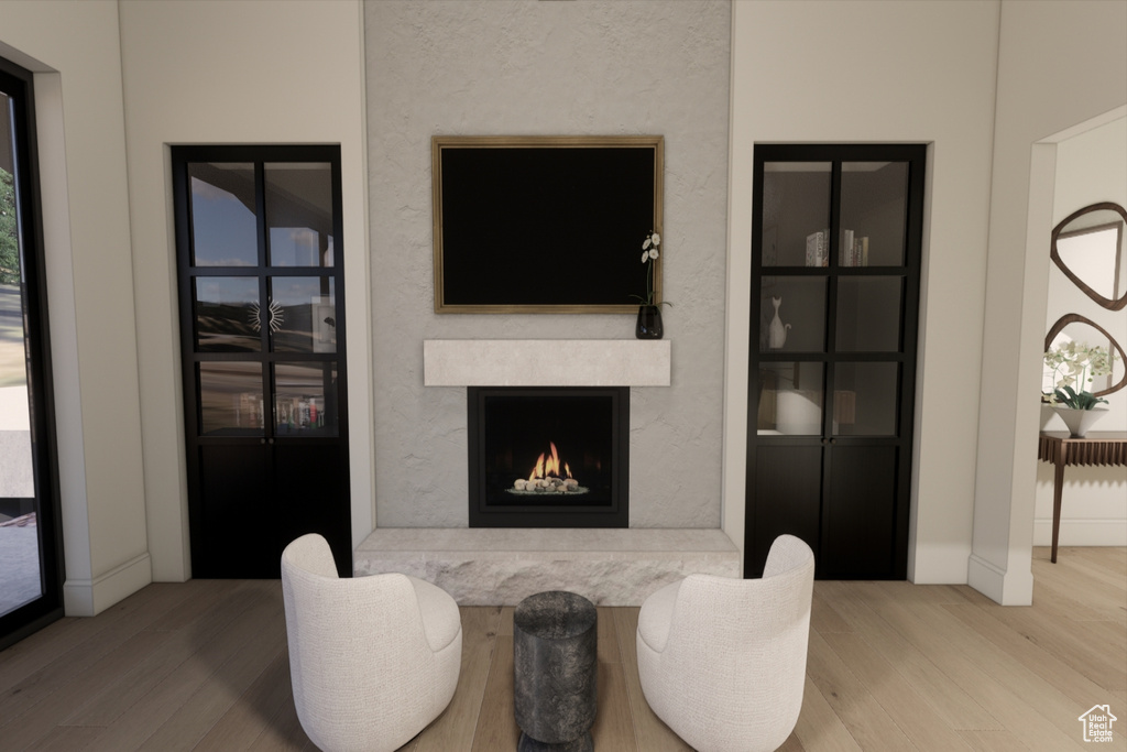 Living room featuring a high end fireplace and hardwood / wood-style flooring