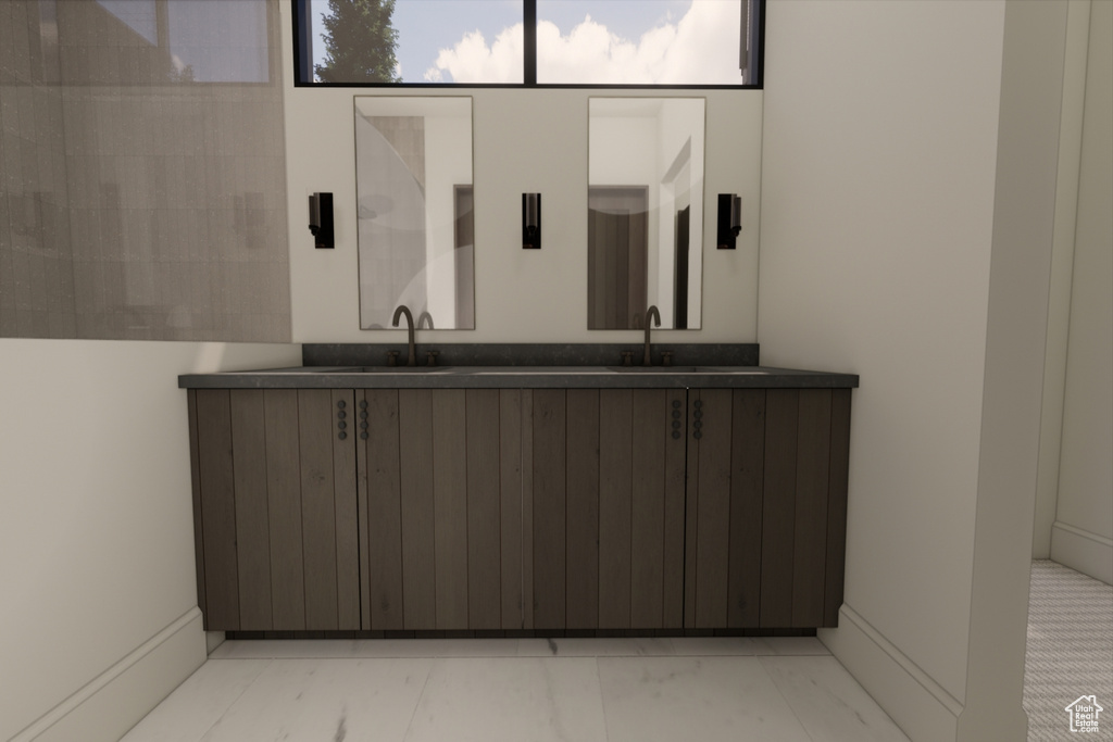 Bathroom with sink and tile patterned flooring