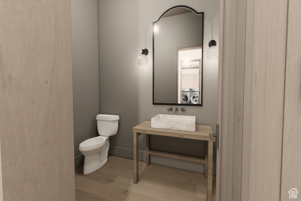 Bathroom with vanity, wood-type flooring, and toilet