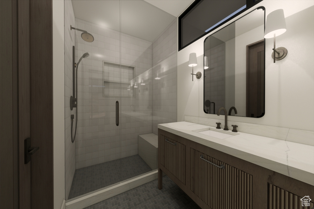 Bathroom featuring a shower with shower door, vanity, and tile patterned flooring